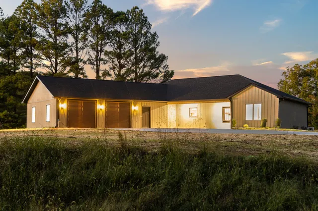 a view of an house with backyard and tree
