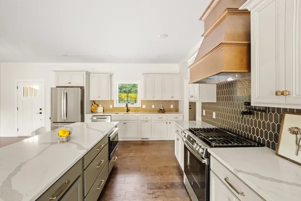 a kitchen with a sink a stove and cabinets