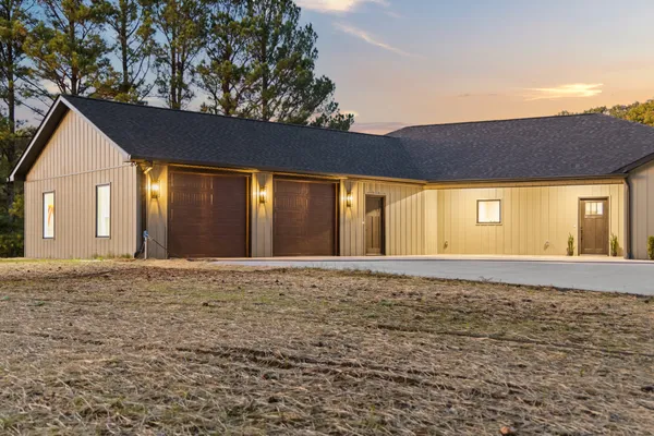a view of an house with backyard space and garden