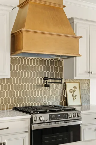 a stove top oven sitting inside of a kitchen
