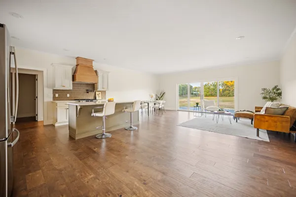 a living room with furniture and a kitchen view