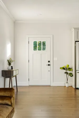 a view of a livingroom with wooden floor and a potted plant