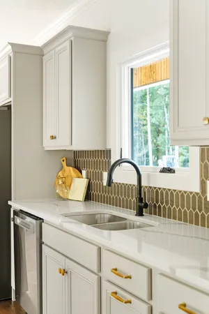 a kitchen with a sink cabinets and window