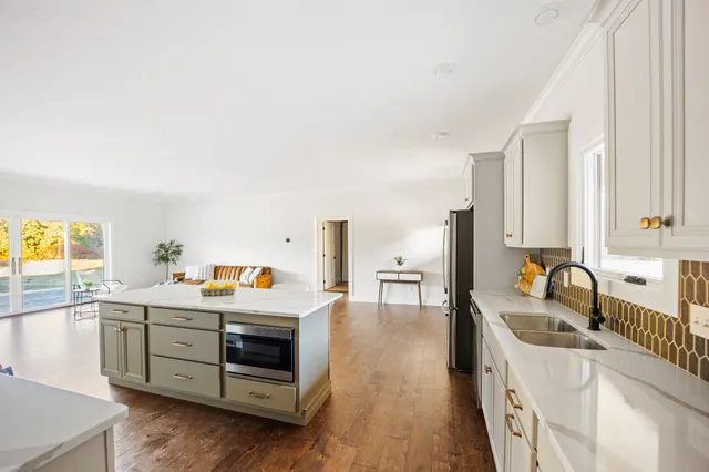 a kitchen with a sink stove and cabinets