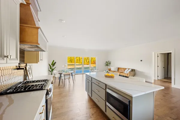 a view of a kitchen with a sink and a refrigerator