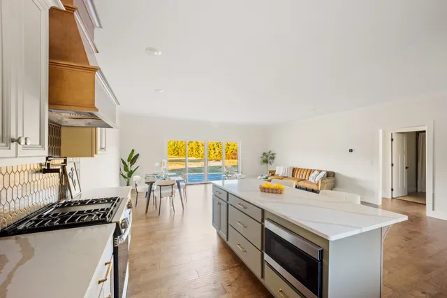 a view of a kitchen with a sink and a refrigerator