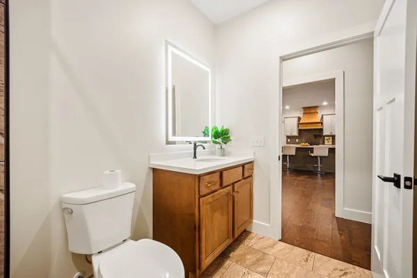 a bathroom with a sink a toilet and a mirror