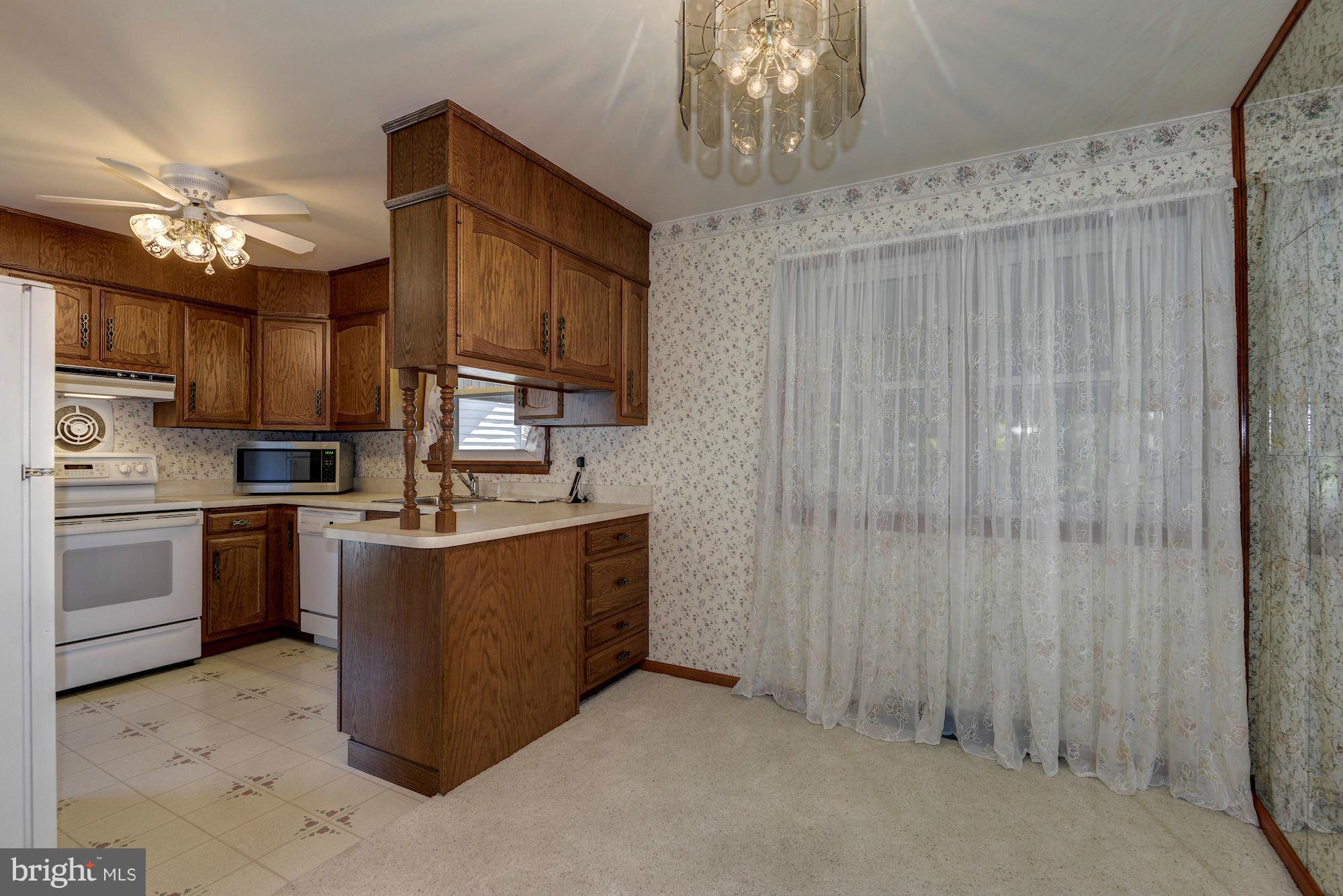 340 Nottingham Road Hagerstown, MD 21740 - Photo 7 of 30 a kitchen with stainless steel appliances granite countertop a stove top oven a sink dishwasher and a refrigerator with wooden cabinets