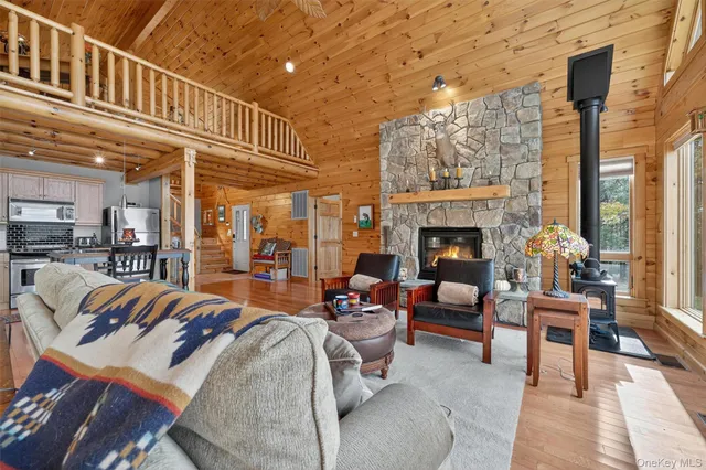 a living room with furniture a fireplace and a table