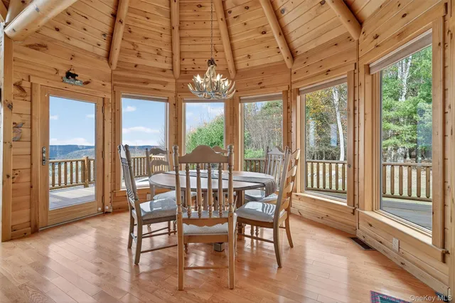 a view of a dining room with furniture large windows and wooden floor