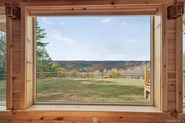 a living room with furniture a fireplace and a chandelier