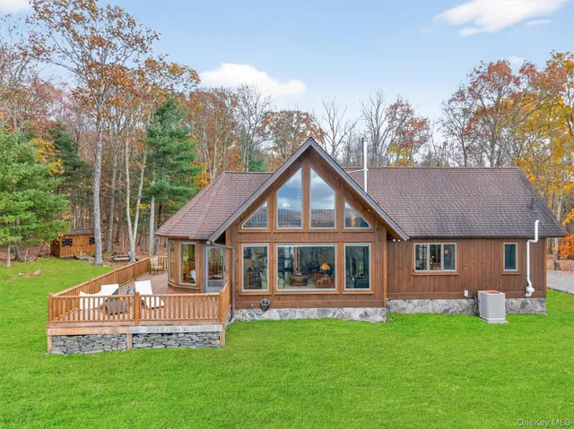 a aerial view of a house with a yard and large trees