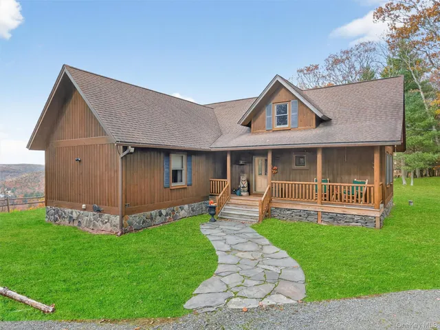 a front view of a house with a yard and fence