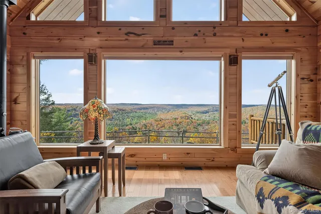 a view of a living room with furniture and a large window