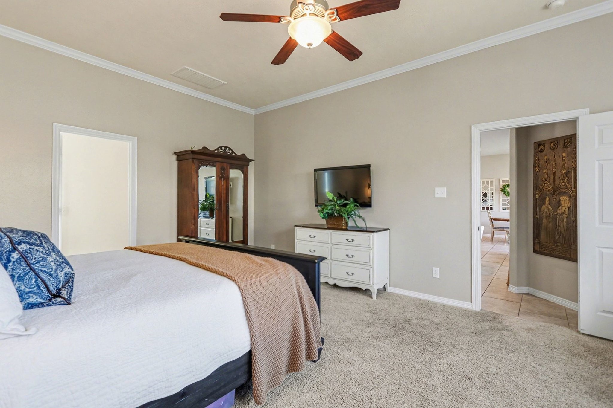 27006 Cliff Pointe Lane Katy, TX 77494 - Photo 19 of 34 A serene primary bedroom with generous layout and natural light, offering comfort, privacy, and flexibility for seating or workspace.
