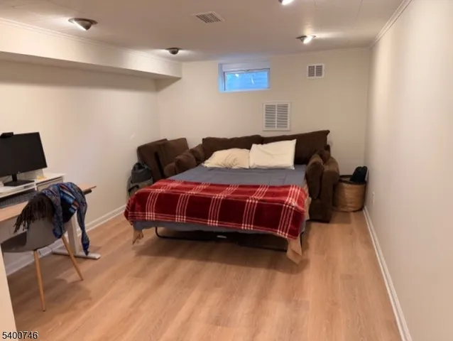 a spacious bedroom with a bed and a chair