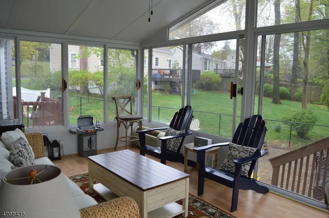 a view of a living room and floor to ceiling window and wooden floor