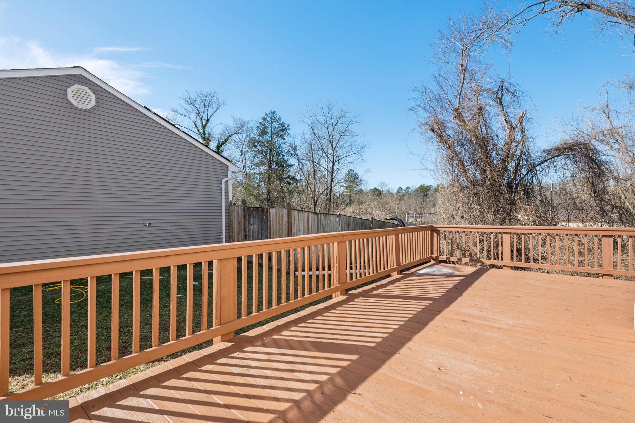7419 Bentree Road Fort Washington, MD 20744 - Photo 25 of 31 a view of balcony with wooden floor and fence