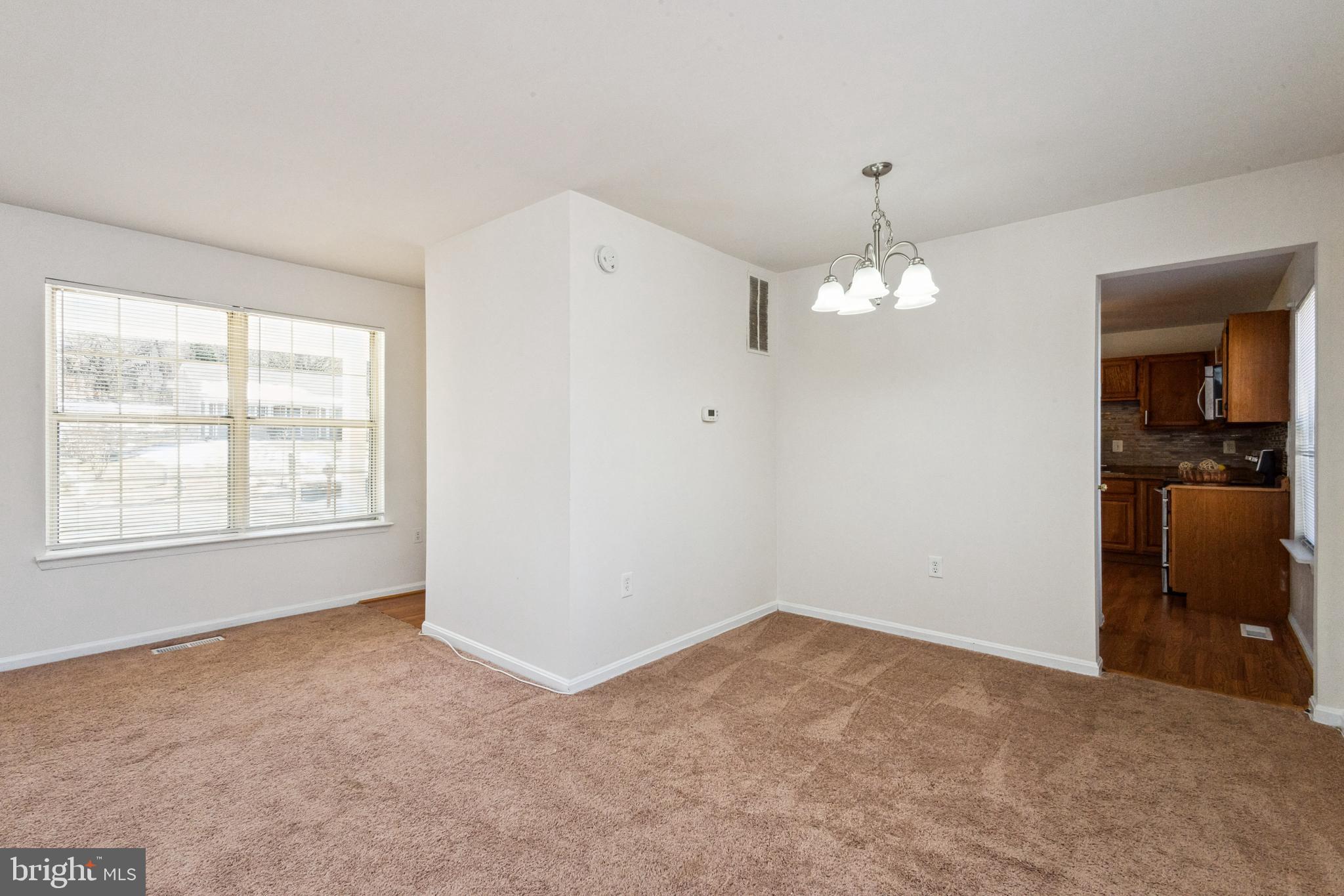 7419 Bentree Road Fort Washington, MD 20744 - Photo 6 of 31 an empty room with chandelier fan and windows