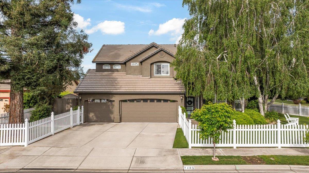 2485 Tigers Drive Turlock, CA 95382 - Photo 1 of 77 a front view of a house with a garden