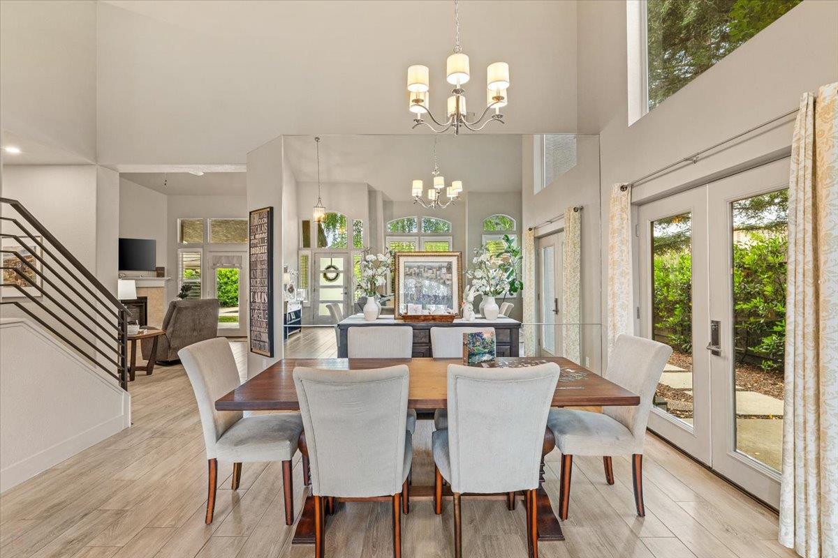 2485 Tigers Drive Turlock, CA 95382 - Photo 19 of 77 a view of a dining room with furniture wooden floor and chandelier