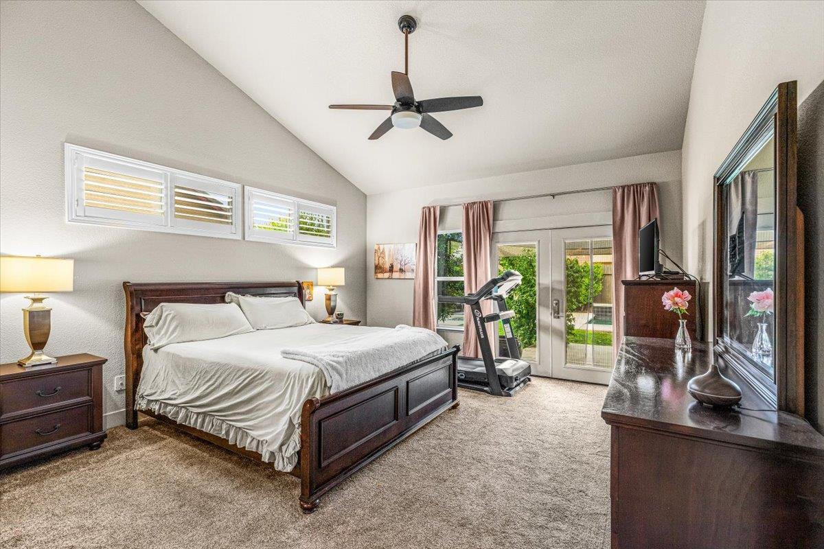 2485 Tigers Drive Turlock, CA 95382 - Photo 40 of 77 a bedroom with a bed and a chandelier