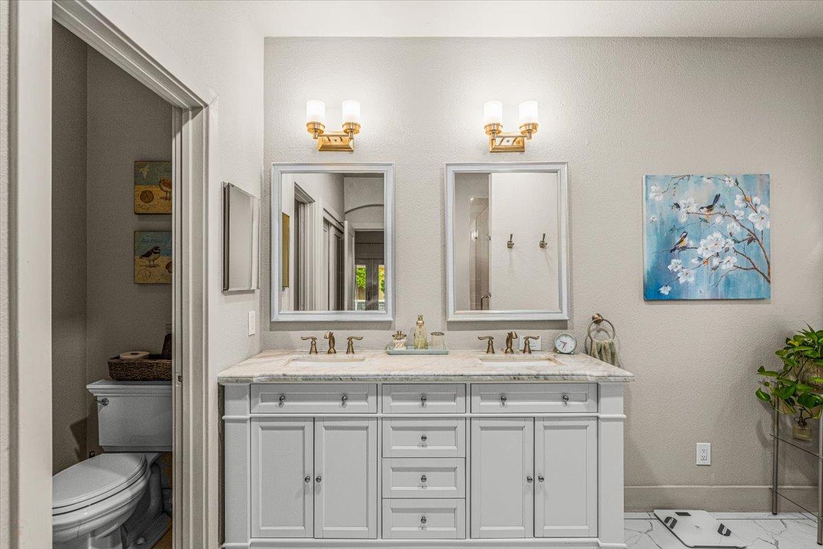 2485 Tigers Drive Turlock, CA 95382 - Photo 43 of 77 a bathroom with a granite countertop sink and a toilet