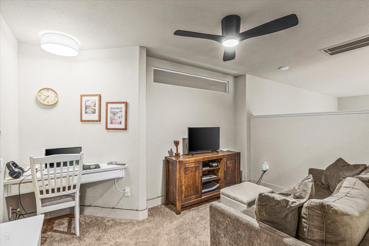 2485 Tigers Drive Turlock, CA 95382 - Photo 50 of 77 a living room with furniture and a flat screen tv