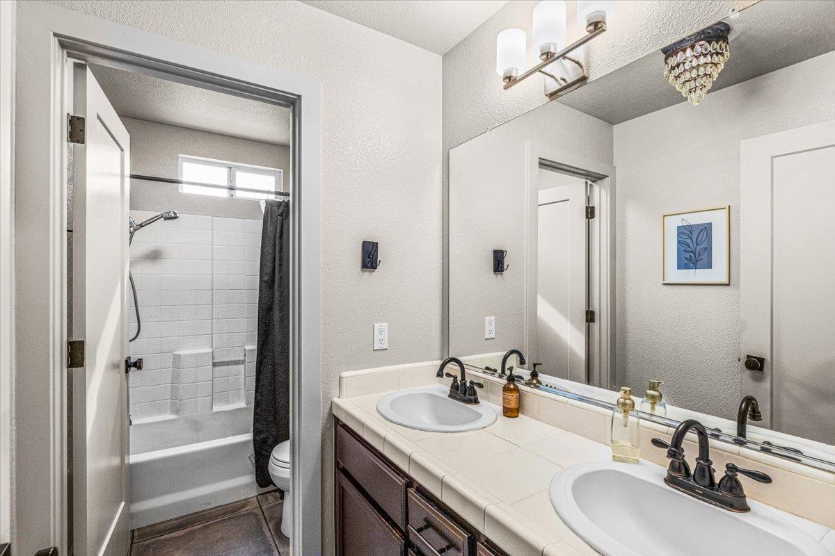 2485 Tigers Drive Turlock, CA 95382 - Photo 54 of 77 a bathroom with a sink a toilet and shower