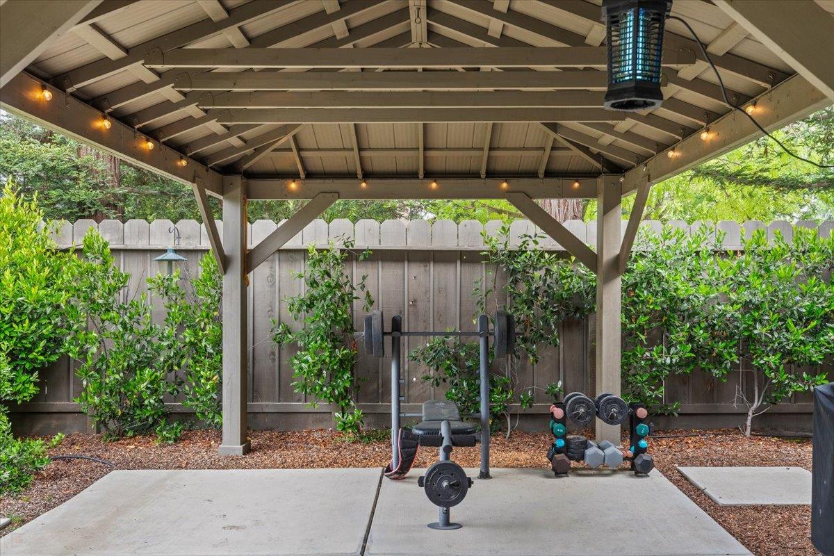 2485 Tigers Drive Turlock, CA 95382 - Photo 59 of 77 a view of a patio with a table and chairs under an umbrella with a small garden