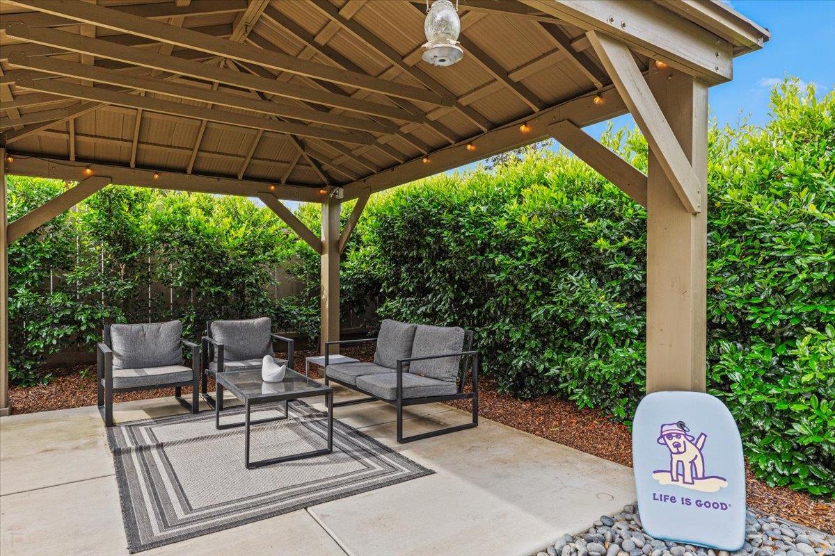 2485 Tigers Drive Turlock, CA 95382 - Photo 70 of 77 a patio with a table and chairs under an umbrella