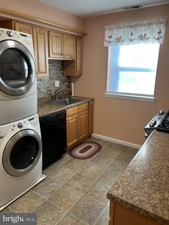 a kitchen with a sink a stove and cabinets