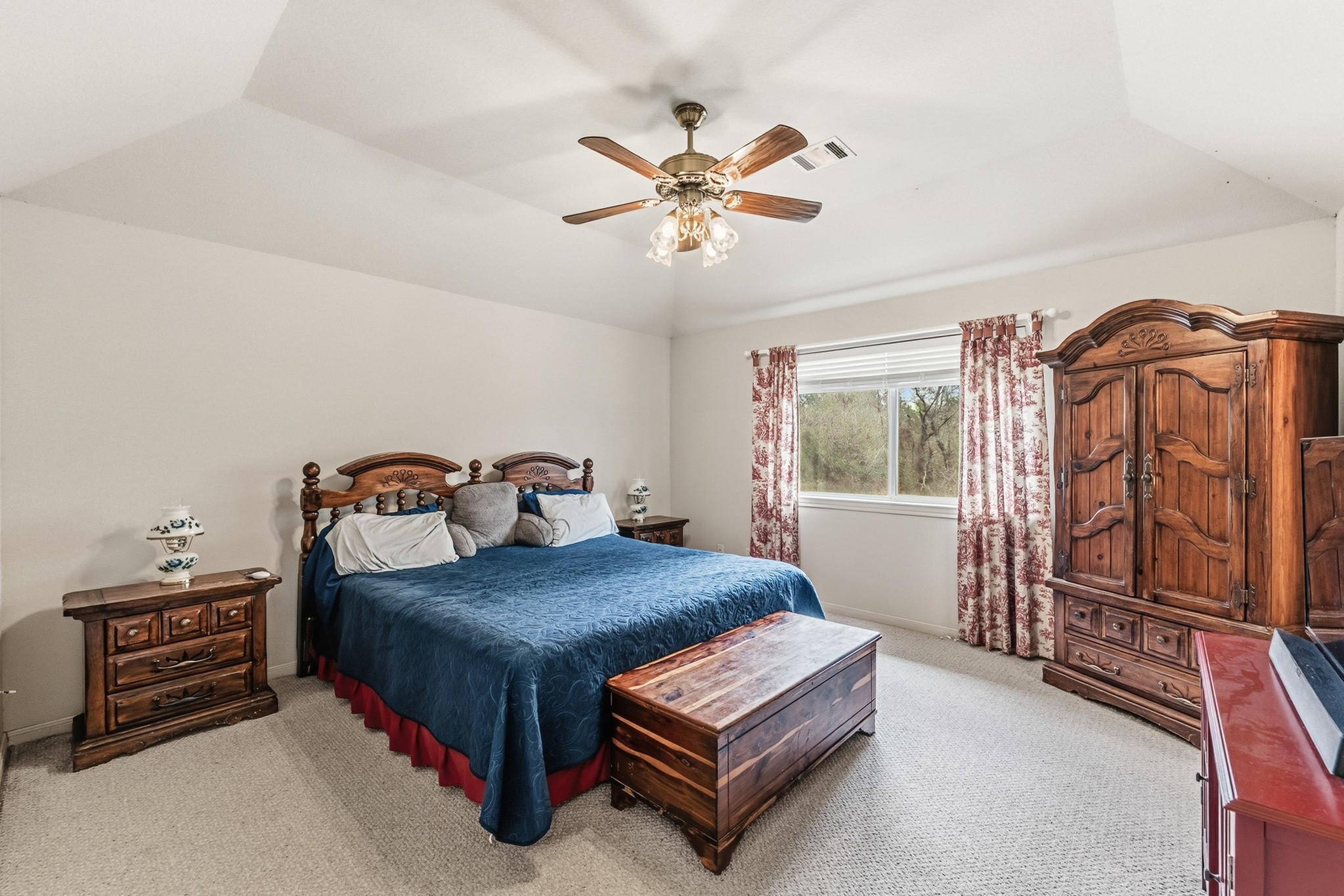691 Bishop Road Huntsville, TX 77320 - Photo 16 of 32 a bedroom with a bed and a chandelier