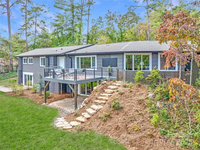 a view of a house with a yard and sitting area