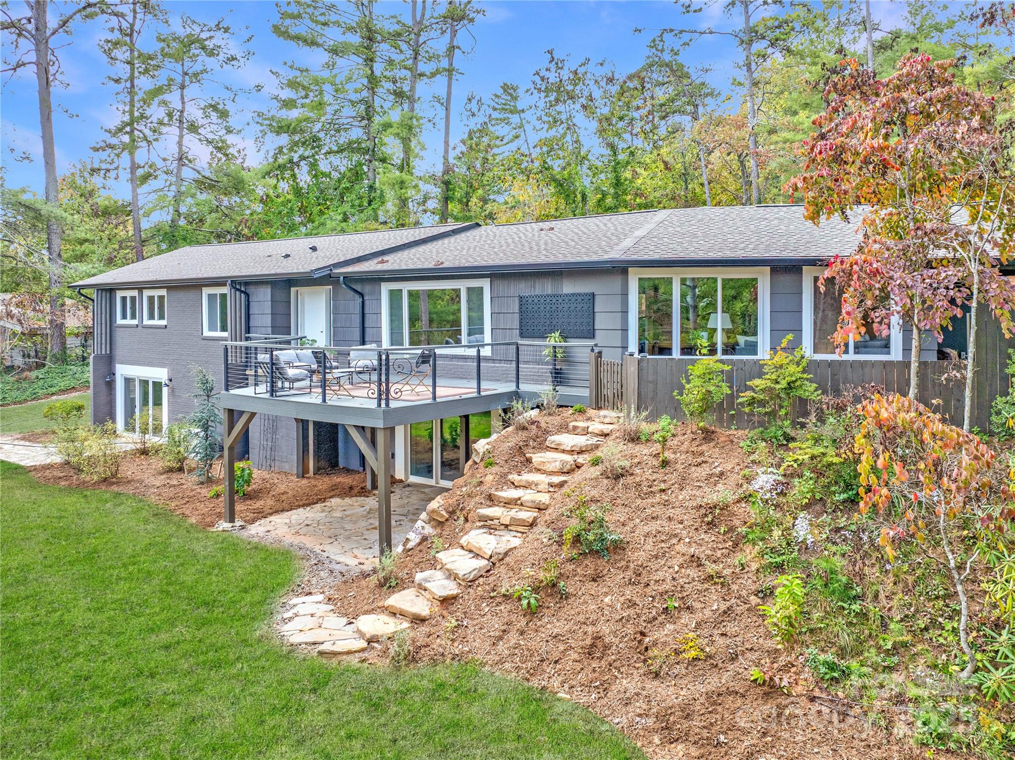 a view of a house with a yard and sitting area