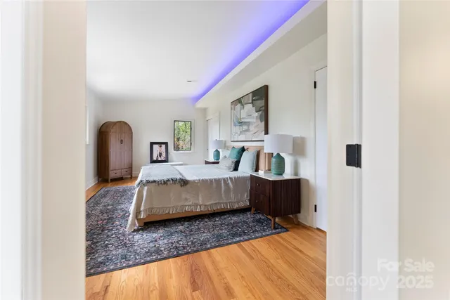 a bedroom with a bed couch and dresser