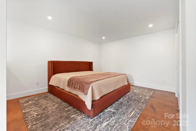 a bedroom with a bed and a rug