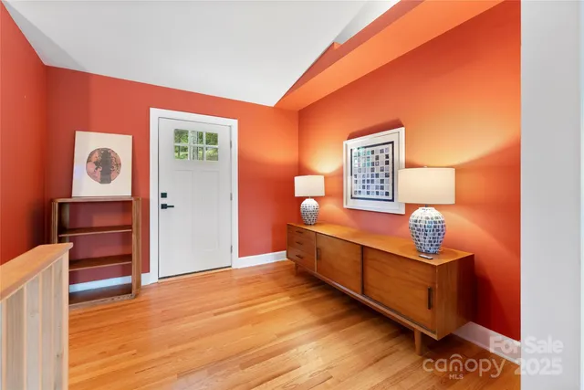 a view of a room with wooden floor