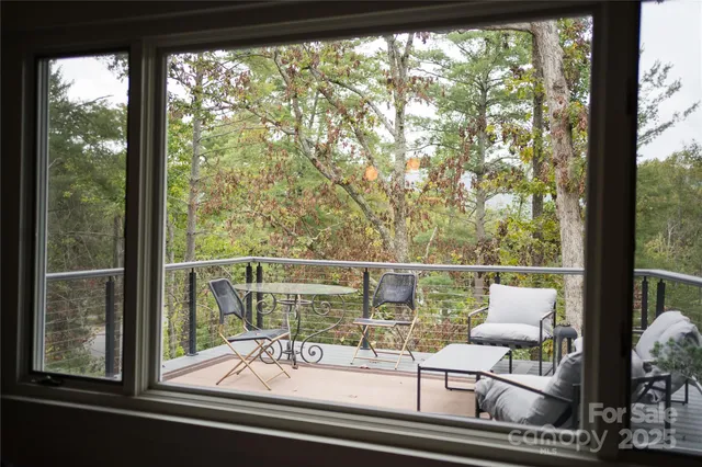 a view of living room with furniture and floor to ceiling window