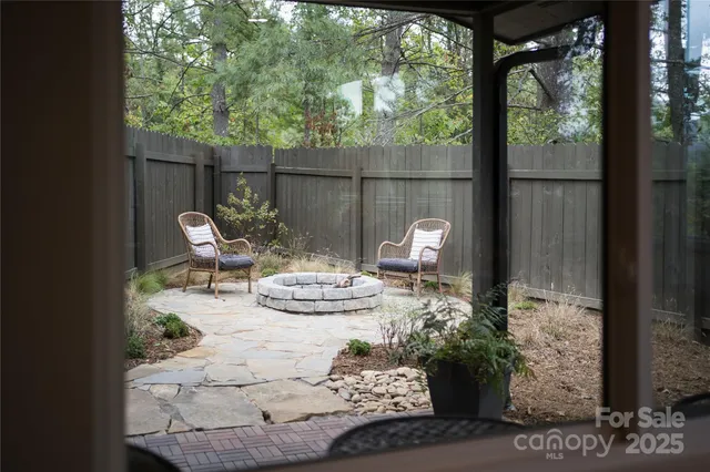 a view of a porch with chairs and backyard
