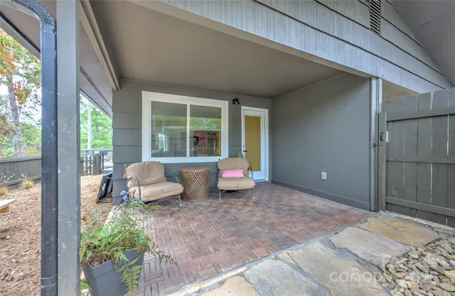 a bedroom with furniture and a large window