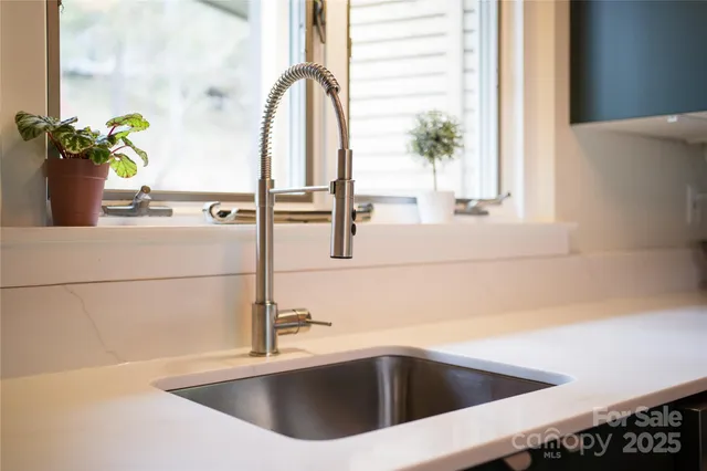 a kitchen with a sink and a window