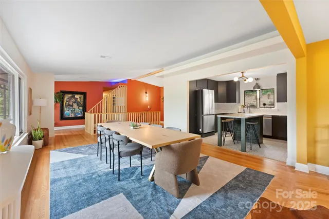a living room with stainless steel appliances kitchen island granite countertop furniture and rug