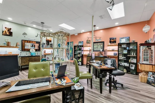 a living room with lots of furniture and a kitchen view