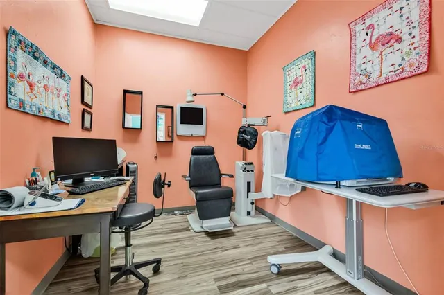 a view of a workspace with furniture and wooden floor
