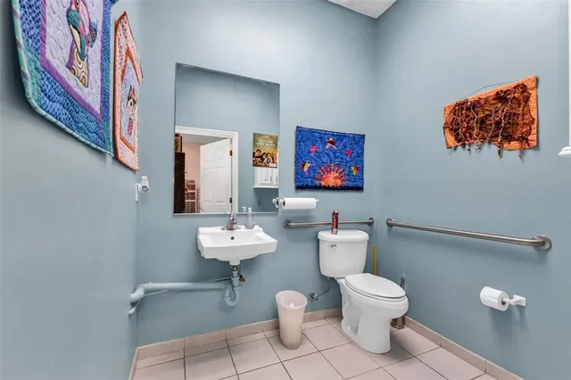 a bathroom with a toilet sink and mirror