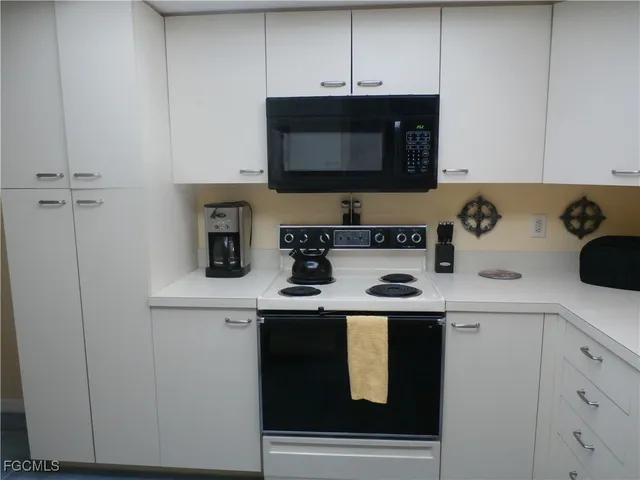 a kitchen with a stove and a microwave