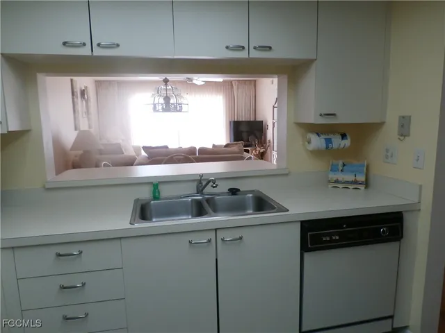 a kitchen with a sink and cabinets