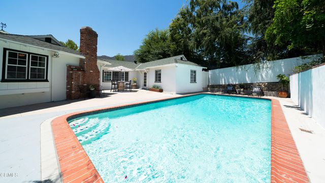 a view of an outdoor kitchen with a swimming pool