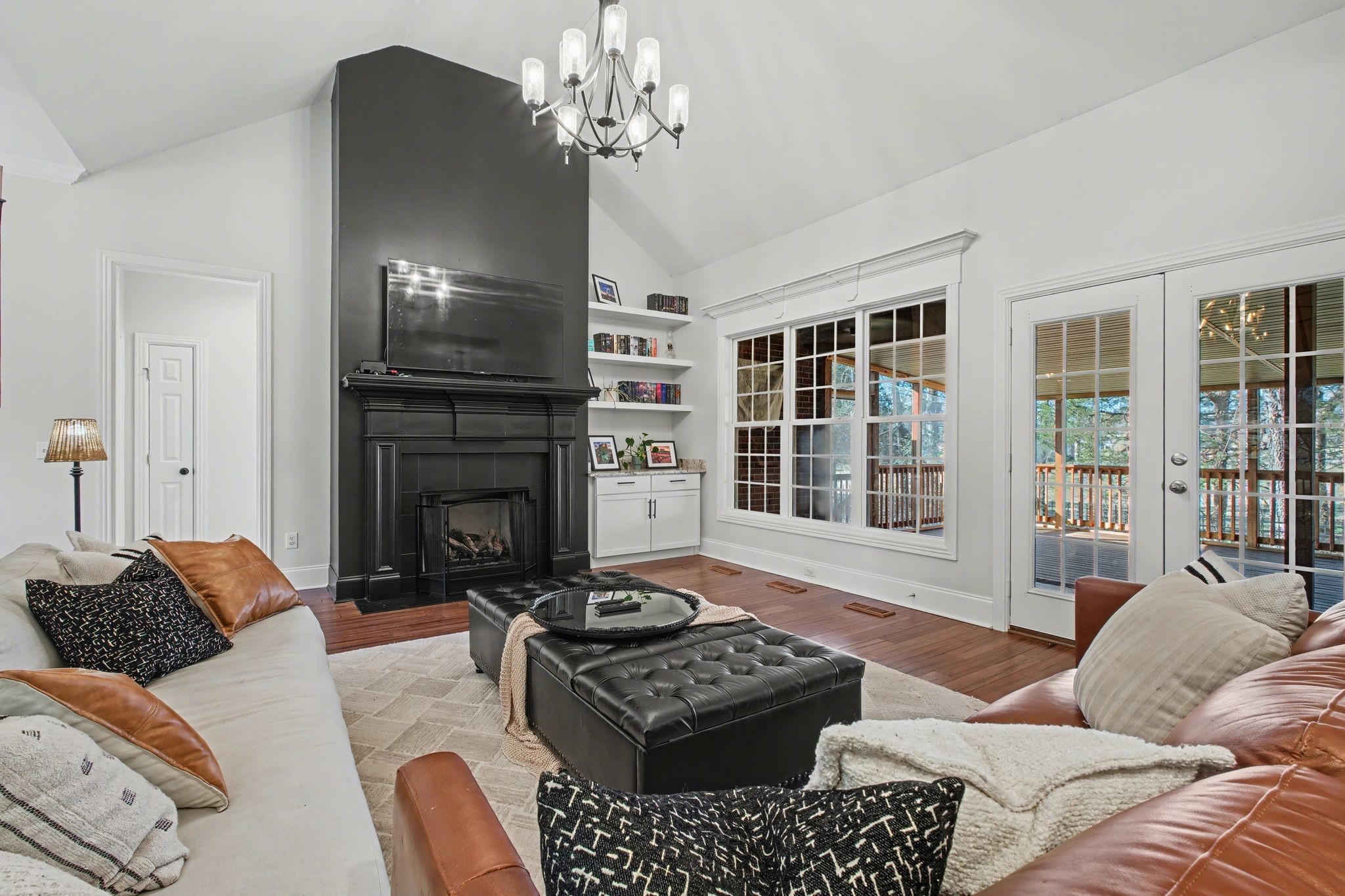701 Deer Ridge Lane Lebanon, TN 37087 - Photo 13 of 41 a living room with furniture a fireplace and a chandelier